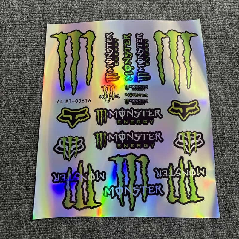 Holographic sticker sheet with various Monster Energy logos and designs, perfect for customizing vehicles and showcasing a bold style.