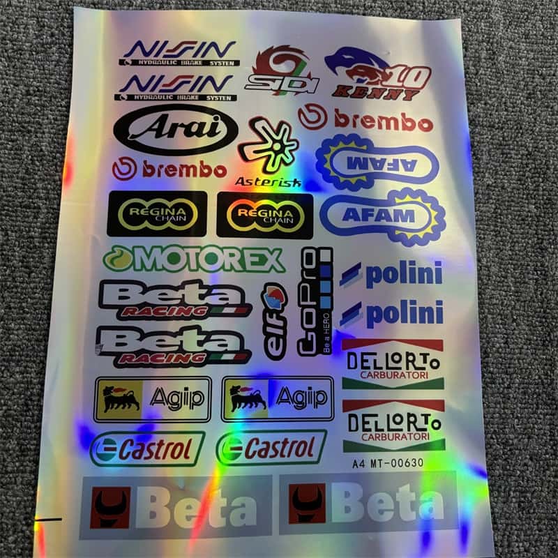 Holographic sticker sheet with motorcycle racing brands like Brembo, Castrol, and Beta, ideal for customizing motorcycles and vehicles to show a racing - inspired style.