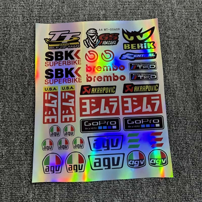 Holographic sticker sheet with motorcycle racing brands like Brembo, GoPro, and Akrapovic, ideal for customizing motorcycles and vehicles to show a racing - inspired style.