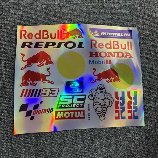 Holographic sticker sheet featuring popular racing brands like Red Bull, Michelin, Honda, Repsol, Mobil 1, SC Project, Motul, and MotoGP graphics for vehicle customization