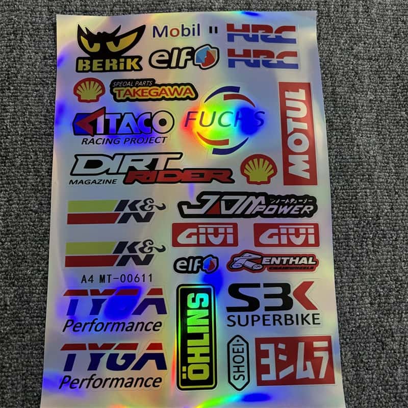 Laser sticker sheet with multiple motorcycle racing and accessory brand logos like Motul, Shell, K&N, and Givi. Ideal for customizing motorcycles to showcase a racing - inspired style with laser visual effects.