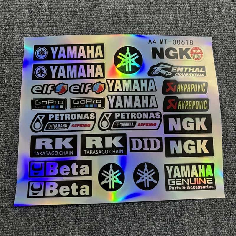 Laser sticker sheet with multiple Yamaha logos, along with Akrapovic, NGK, and other related designs. Ideal for customizing Yamaha motorcycles to showcase a racing - inspired style with laser visual effects.