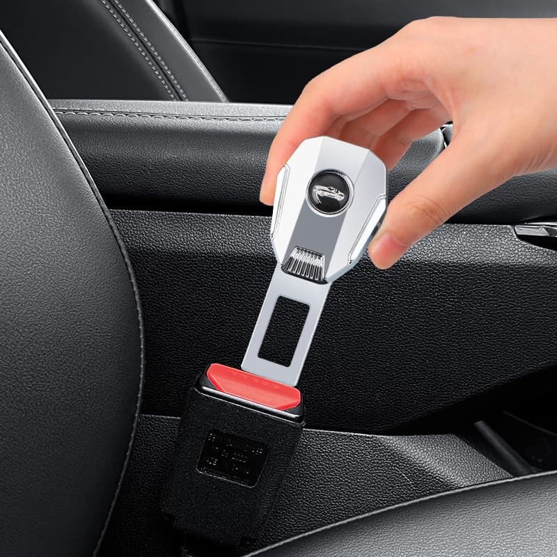 Silver car seat belt extender in use, showing a hand installing the seat belt extender into a car's seat belt buckle. This auto accessory is designed to enhance seat belt convenience and safety, making it easier for drivers and passengers to fasten their seat belts comfortably.